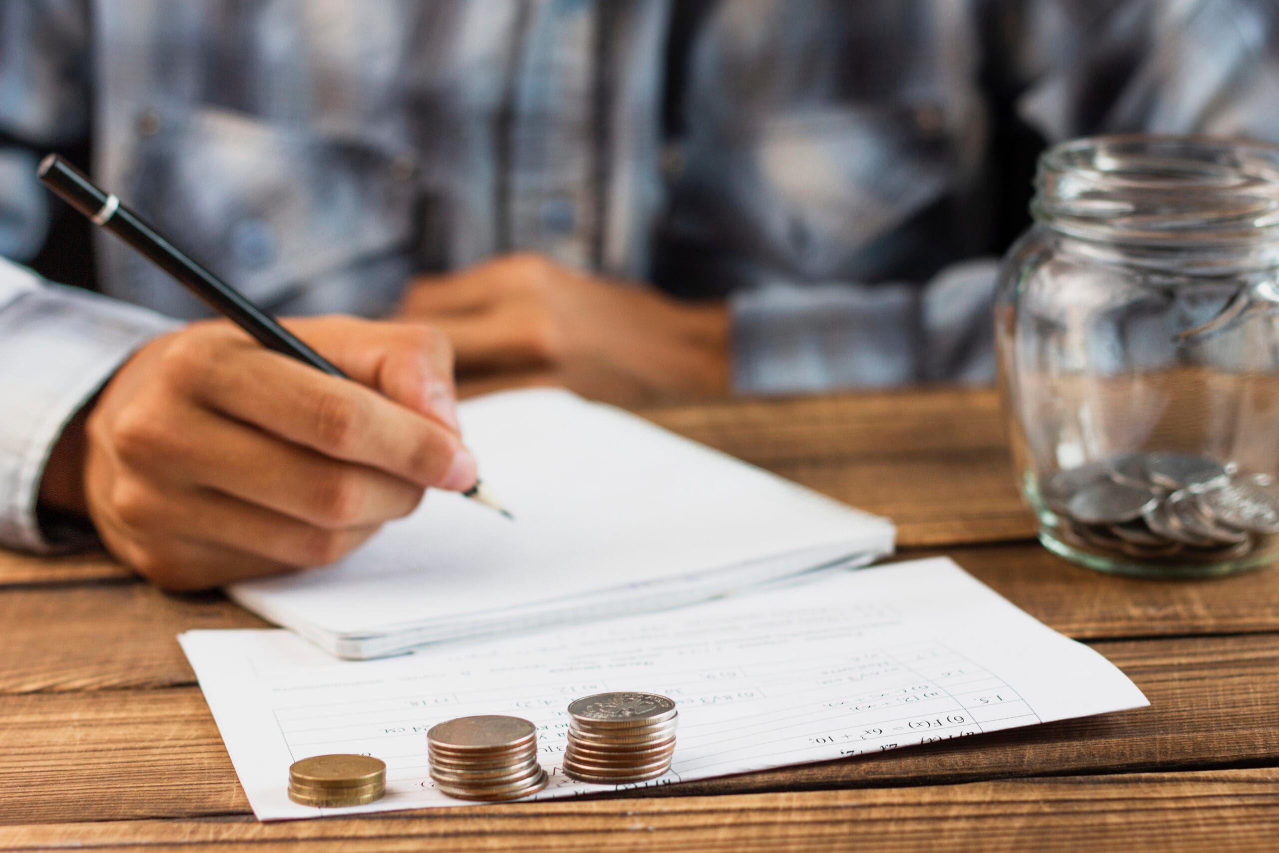 man with saving jar counting scaled